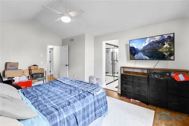 bedroom featuring ceiling fan, wood finished floors, visible vents, baseboards, and lofted ceiling