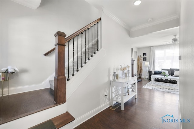 staircase with baseboards, a ceiling fan, crown molding, and wood finished floors