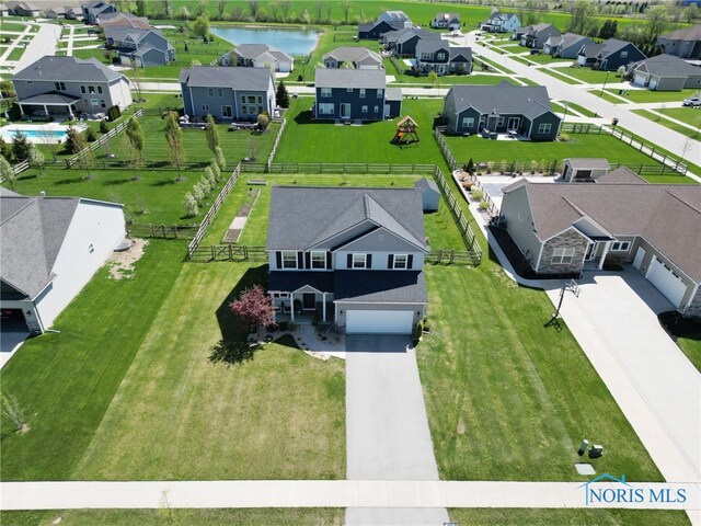 drone / aerial view with a water view and a residential view