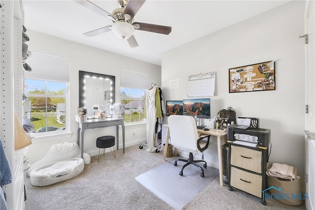 office space with carpet floors, ceiling fan, and baseboards