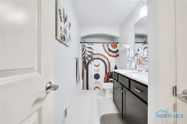 bathroom featuring vanity, tile patterned flooring, visible vents, and toilet
