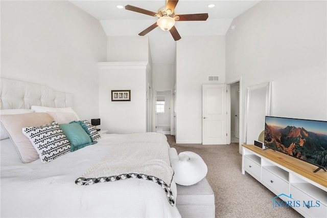 bedroom featuring visible vents, baseboards, ceiling fan, high vaulted ceiling, and carpet flooring