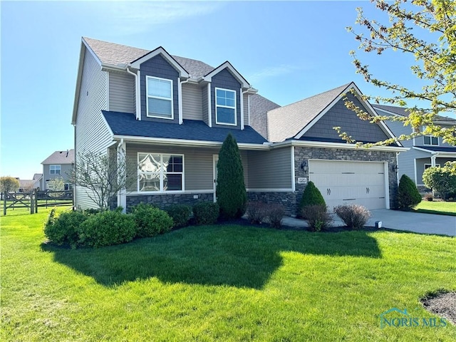 craftsman-style house with a front lawn, a garage, stone siding, concrete driveway, and fence
