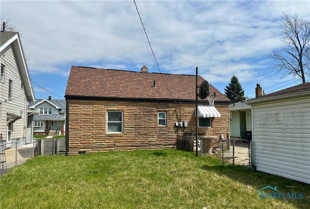 4865 296th St, Toledo, OH 43611 - back of house with a lawn, roof with shingles, and fence