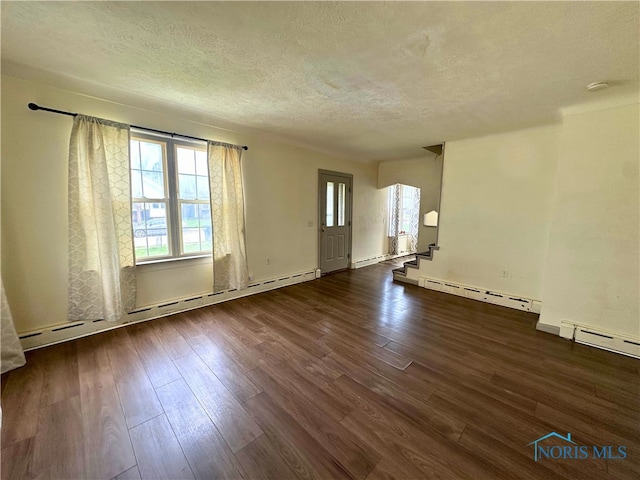 4865 296th St, Toledo, OH 43611 - spare room featuring baseboard heating, wood finished floors, and a textured ceiling
