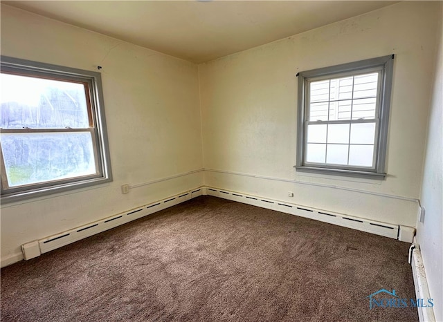4865 296th St, Toledo, OH 43611 - unfurnished room featuring baseboard heating, dark colored carpet, a baseboard heating unit, and plenty of natural light