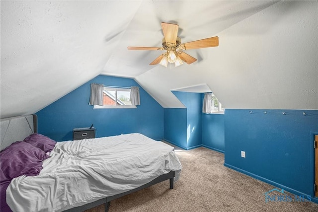 carpeted bedroom featuring baseboards, a ceiling fan, and vaulted ceiling