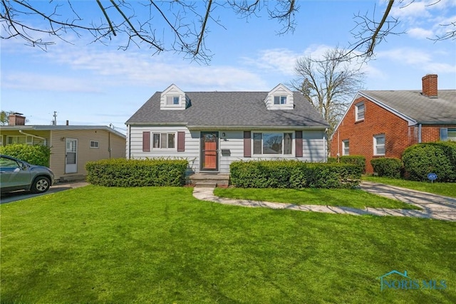 cape cod-style house featuring a front yard