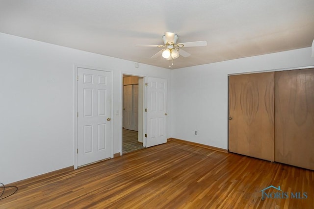 400 Orchard View Dr, Maumee, OH 43537 - unfurnished bedroom with wood finished floors, a closet, baseboards, and a ceiling fan