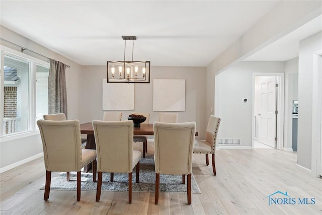544 Jacqueline Ct, Holland, OH 43528 - dining space with light wood-style flooring, a chandelier, and baseboards
