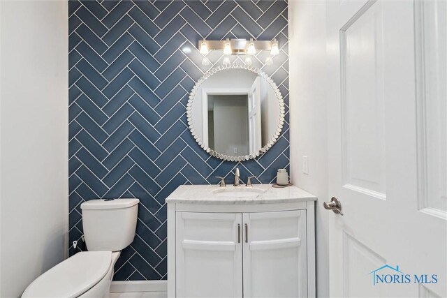 544 Jacqueline Ct, Holland, OH 43528 - half bathroom with tile walls, toilet, and vanity