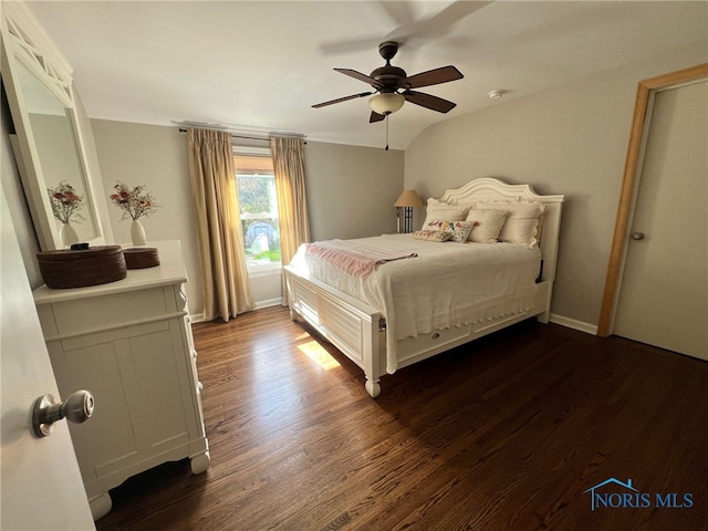 bedroom featuring ceiling fan, baseboards, and dark wood-type flooring