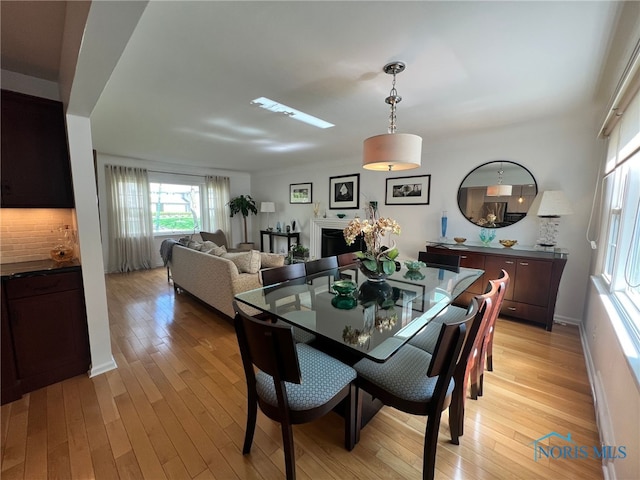 dining space featuring light wood-style floors