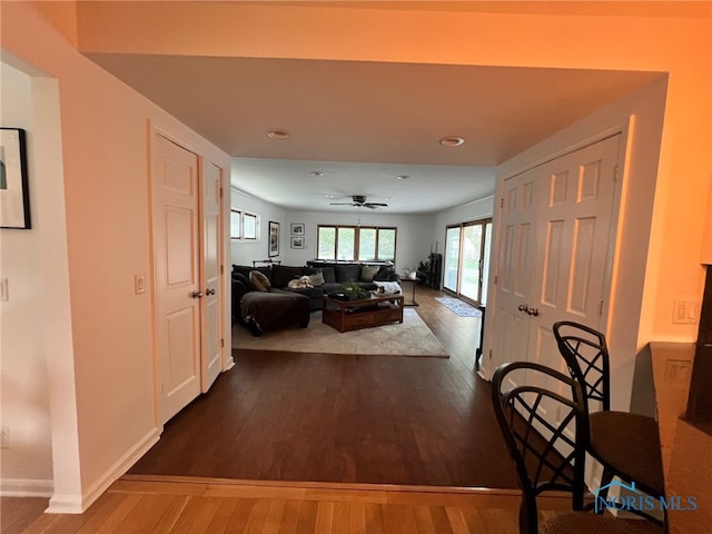 living room featuring baseboards, recessed lighting, ceiling fan, and dark wood-style flooring