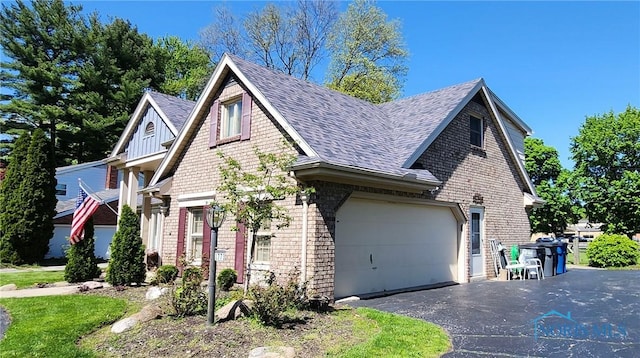 1773 Valley Way Dr, Toledo, OH 43614 - view of front of property featuring a shingled roof, driveway, brick siding, and an attached garage