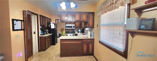 1773 Valley Way Dr, Toledo, OH 43614 - kitchen featuring a ceiling fan, freestanding refrigerator, electric stove, light countertops, and dark brown cabinetry