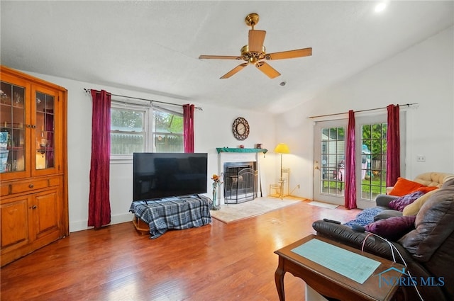 705 Reineck Dr, Toledo, OH 43605 - living room with a glass covered fireplace, a ceiling fan, wood finished floors, and lofted ceiling