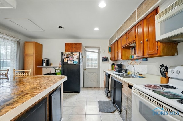 705 Reineck Dr, Toledo, OH 43605 - kitchen with brown cabinets, a sink, light countertops, recessed lighting, and black appliances