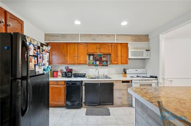 705 Reineck Dr, Toledo, OH 43605 - kitchen featuring light countertops, brown cabinets, a sink, light tile patterned floors, and black appliances