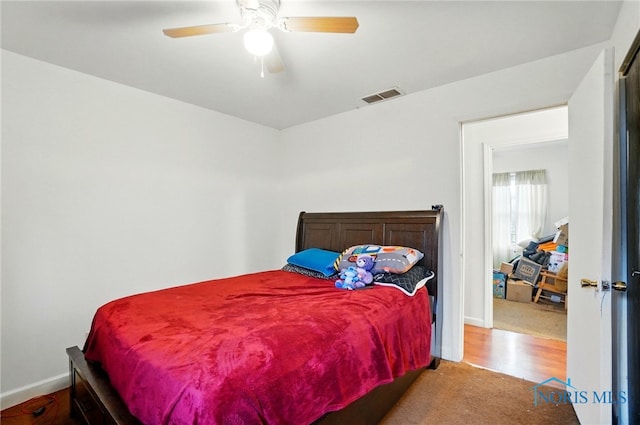 705 Reineck Dr, Toledo, OH 43605 - bedroom with visible vents, baseboards, ceiling fan, and wood finished floors