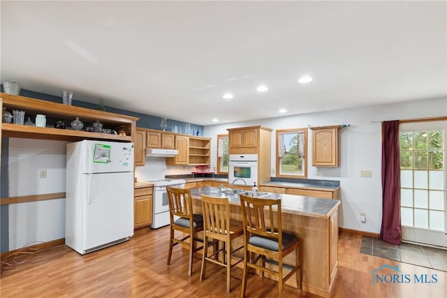 kitchen with open shelves, light wood finished floors, under cabinet range hood, recessed lighting, and white appliances