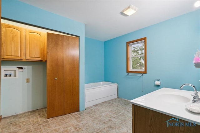 full bathroom with a garden tub and vanity