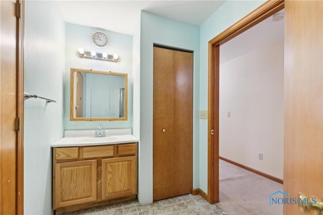 bathroom with baseboards and vanity