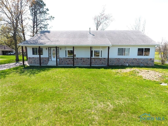ranch-style house with a shingled roof, stone siding, and a front lawn