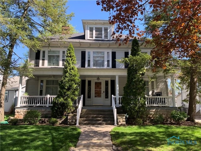 view of front of home featuring a porch and a front yard