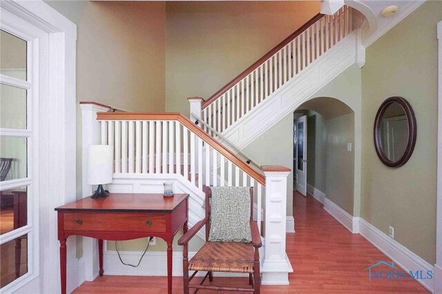 202 Hancock St, Findlay, OH 45840 - stairway with arched walkways, wood finished floors, and baseboards