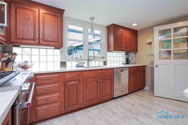 202 Hancock St, Findlay, OH 45840 - kitchen featuring stainless steel dishwasher, a sink, brown cabinets, backsplash, and recessed lighting