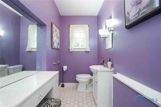 202 Hancock St, Findlay, OH 45840 - bathroom featuring toilet, vanity, and baseboards