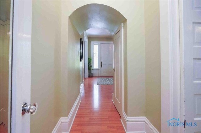202 Hancock St, Findlay, OH 45840 - hall with arched walkways, wood finished floors, and baseboards