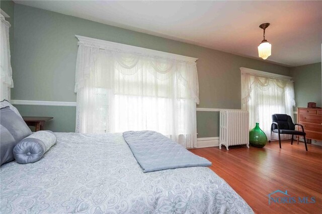 202 Hancock St, Findlay, OH 45840 - bedroom featuring radiator and wood finished floors