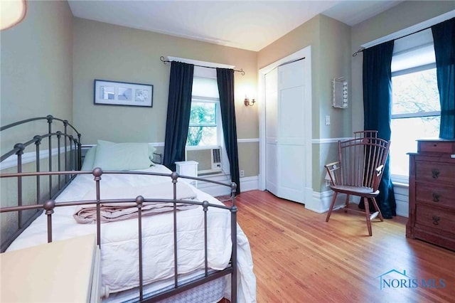 202 Hancock St, Findlay, OH 45840 - bedroom featuring wood finished floors, multiple windows, and baseboards