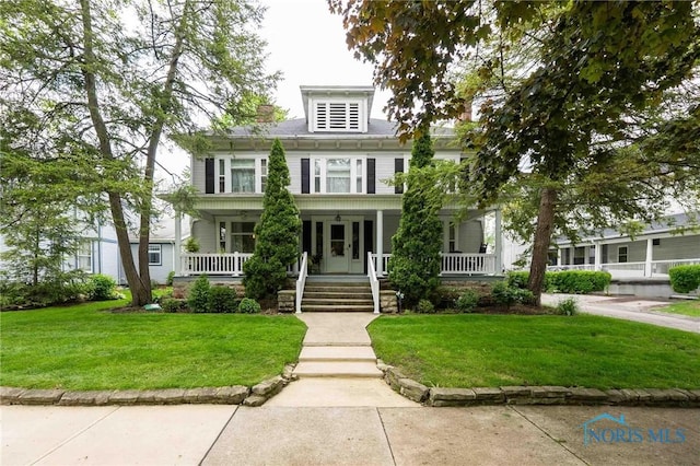 202 Hancock St, Findlay, OH 45840 - american foursquare style home featuring a porch and a front lawn
