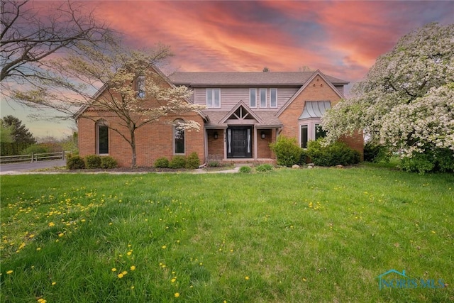 6142 Welsford Ct, Maumee, OH 43537 - view of front of house with fence, a yard, and brick siding