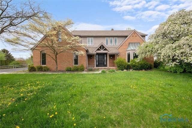 6142 Welsford Ct, Maumee, OH 43537 - traditional-style home featuring fence, a front lawn, and brick siding