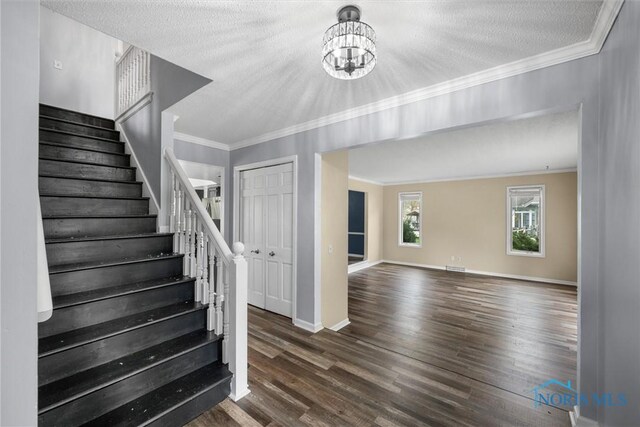 6142 Welsford Ct, Maumee, OH 43537 - stairs featuring ornamental molding, wood finished floors, baseboards, a textured ceiling, and a chandelier