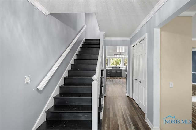 6142 Welsford Ct, Maumee, OH 43537 - stairs featuring baseboards, ornamental molding, a textured ceiling, and wood finished floors
