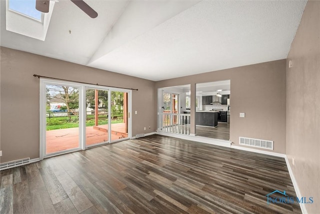 6142 Welsford Ct, Maumee, OH 43537 - unfurnished living room with ceiling fan, baseboards, wood finished floors, visible vents, and lofted ceiling with skylight