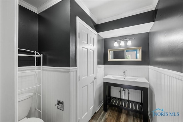 6142 Welsford Ct, Maumee, OH 43537 - bathroom with crown molding, toilet, wood finished floors, and a wainscoted wall