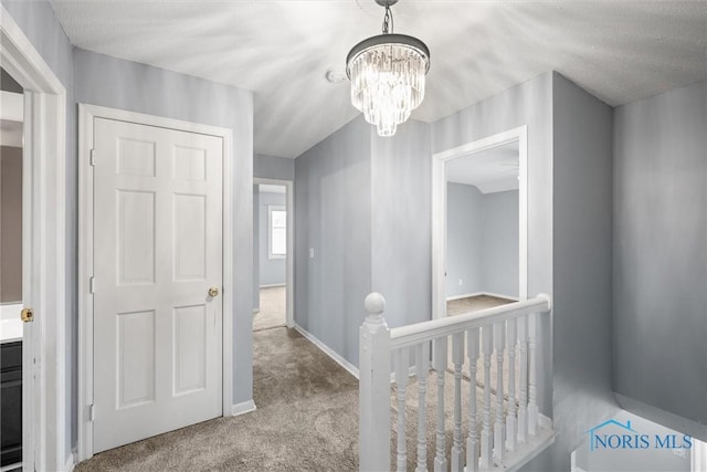 6142 Welsford Ct, Maumee, OH 43537 - hallway with carpet floors, baseboards, a notable chandelier, and an upstairs landing