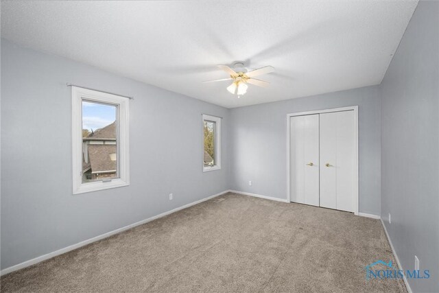 6142 Welsford Ct, Maumee, OH 43537 - unfurnished bedroom with baseboards, a ceiling fan, carpet, and a closet