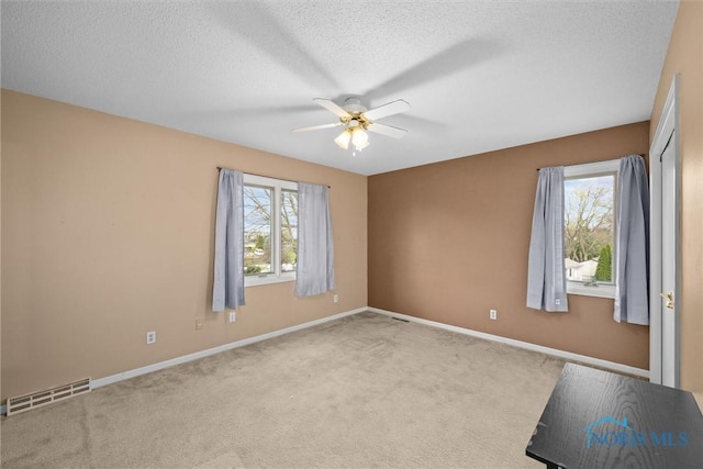 6142 Welsford Ct, Maumee, OH 43537 - spare room with ceiling fan, a textured ceiling, visible vents, baseboards, and carpet