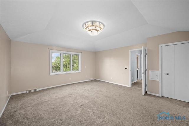6142 Welsford Ct, Maumee, OH 43537 - unfurnished bedroom with carpet floors, baseboards, vaulted ceiling, and visible vents