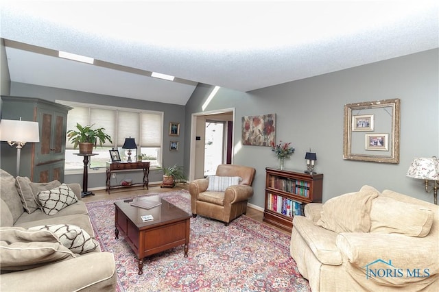 living room featuring baseboards, vaulted ceiling, and light wood-style floors