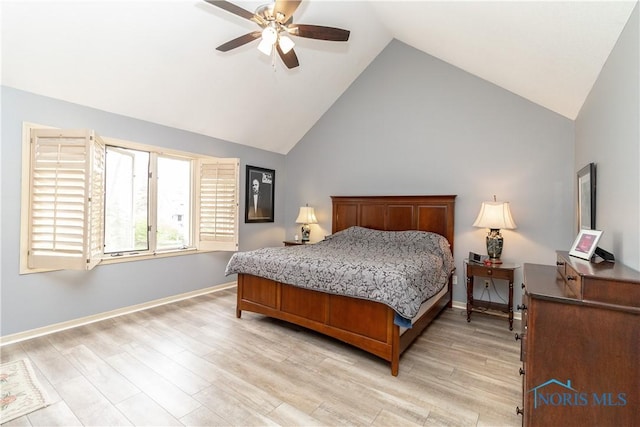 bedroom with light wood-style floors, high vaulted ceiling, baseboards, and ceiling fan