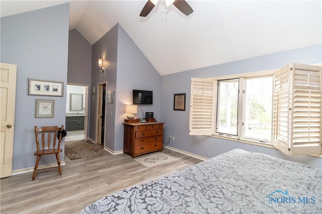bedroom with light wood-style floors, baseboards, ceiling fan, high vaulted ceiling, and connected bathroom