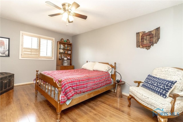 bedroom with baseboards, a ceiling fan, and wood finished floors